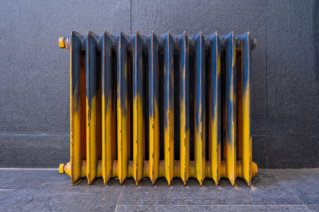 grunge iron retro radiator painted with blue and yellow