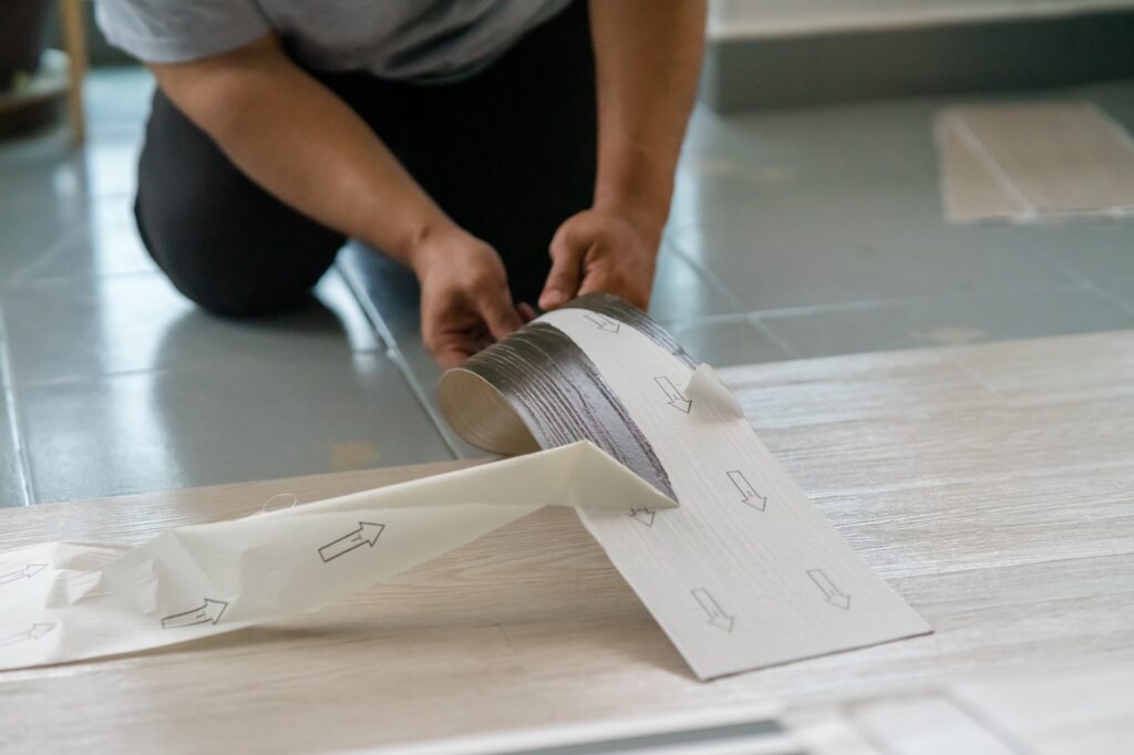 Installing vinyl flooring.