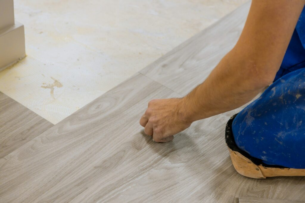 Work of the room for laying laminate on wood texture floor